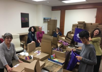 More volunteers packing Beyond Differences backpacks