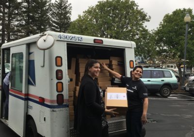 Volunteers loading a mail truck with Beyond Differences packages