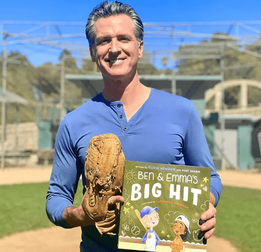 Image of Governor Gavin Newsom holding a copy of his book, "Ben & Emma's Big Hit"