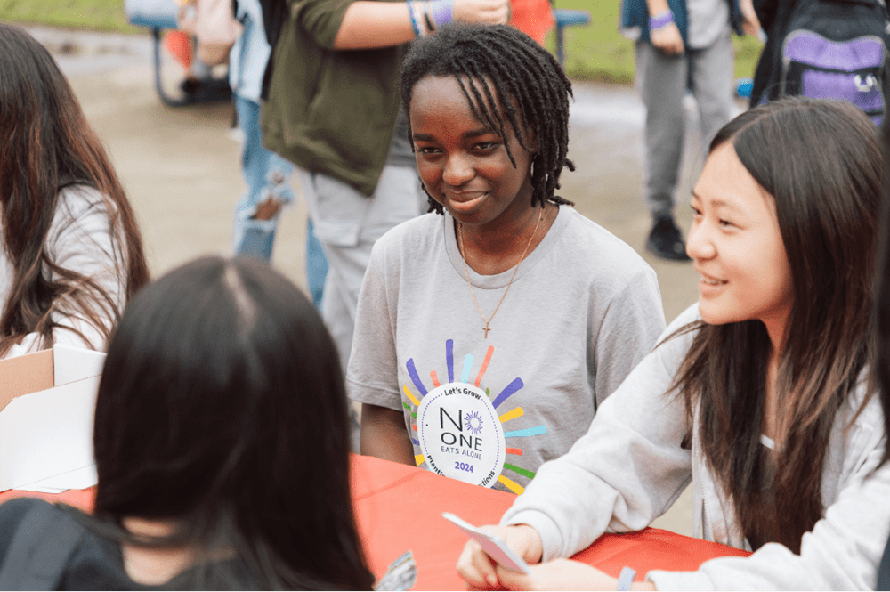 Students celebrating No One Eats Alone Day at their school